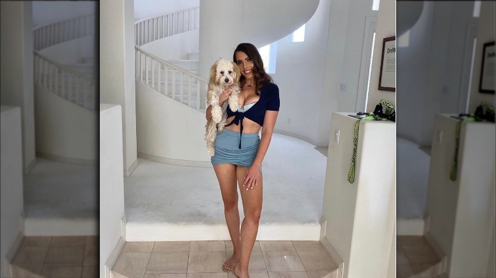 Victoria Larson posing with a dog in front of stairs