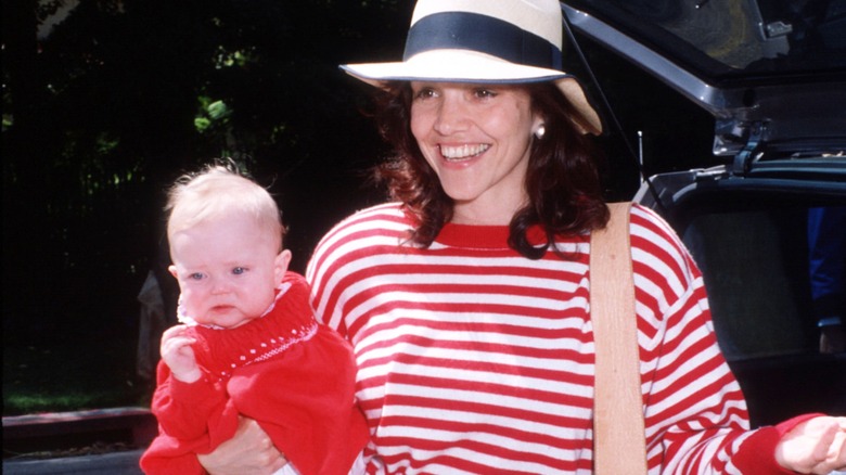 Brooke Adams carrying Josie Adams in 1989