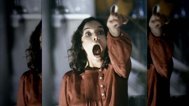 Brooke Adams, openmouthed and pointing, in Invasion of the Body Snatchers