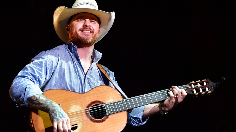 Cody Johnson on stage with a guitar