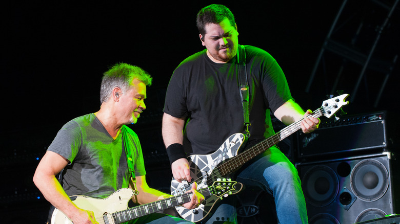 Eddie and Wolfgang Van Halen playing guitars on stage together