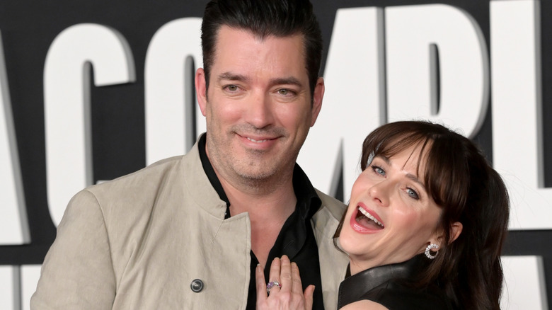 Zooey Deschanel hand on Jonathan Scott's chest smiling