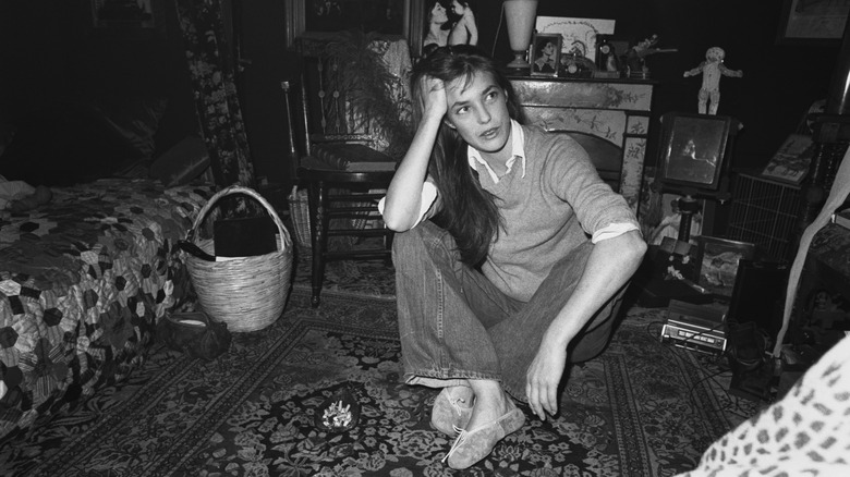 Jane Birkin with bangs sat on floor