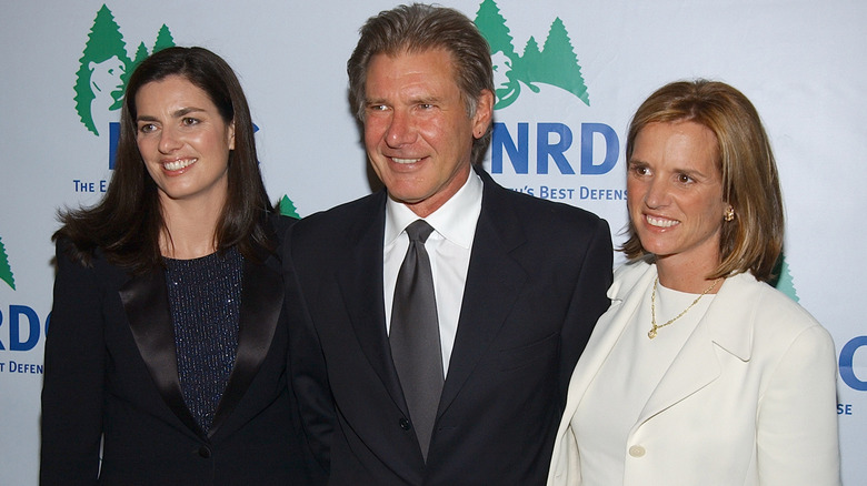 Mary Richardson, Harrison Ford, and Kerry Kennedy posing for photo on step-and-repeat