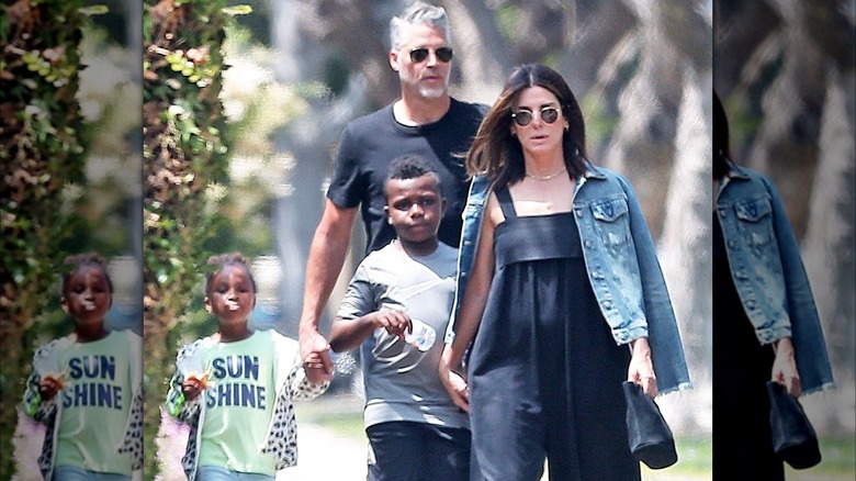 Bryan Randall and Sandra Bullock walking with family