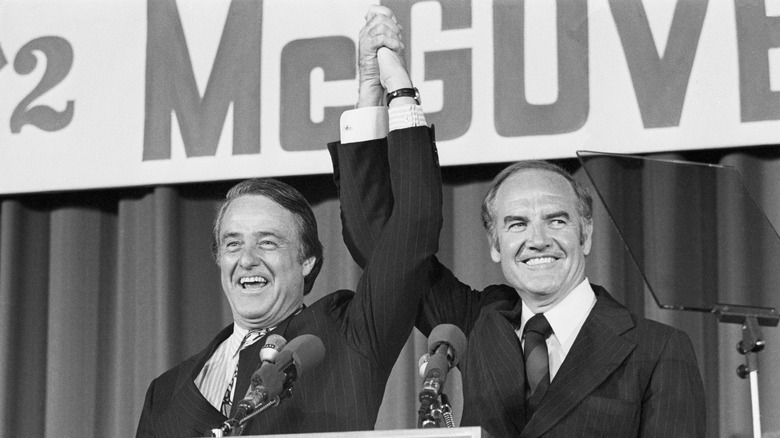 Sargent Shriver and George McGovern raising hands