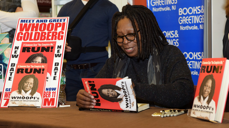 Whoopi Goldberg signing her book