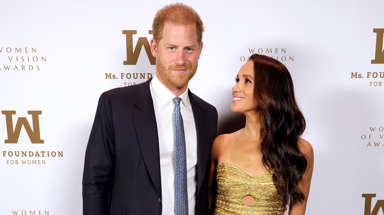 Prince Harry and Meghan Markle posing on the red carpet