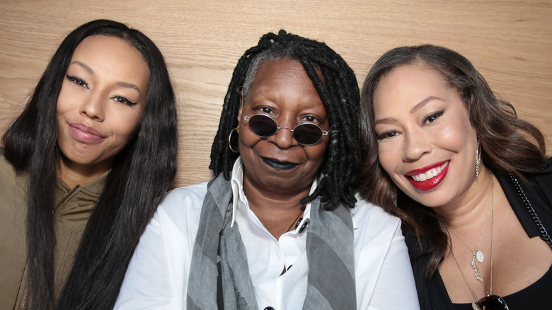 Whoopi Goldberg posing with Alex Martin and granddaughter