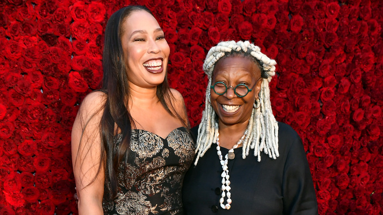 Whoopi Goldberg and Alex Martin laughing