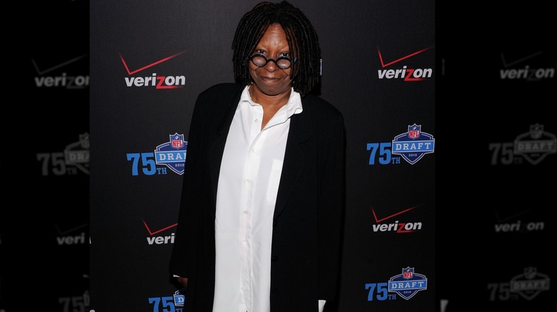 Whoopi Goldberg looking directly at the camera and smiling