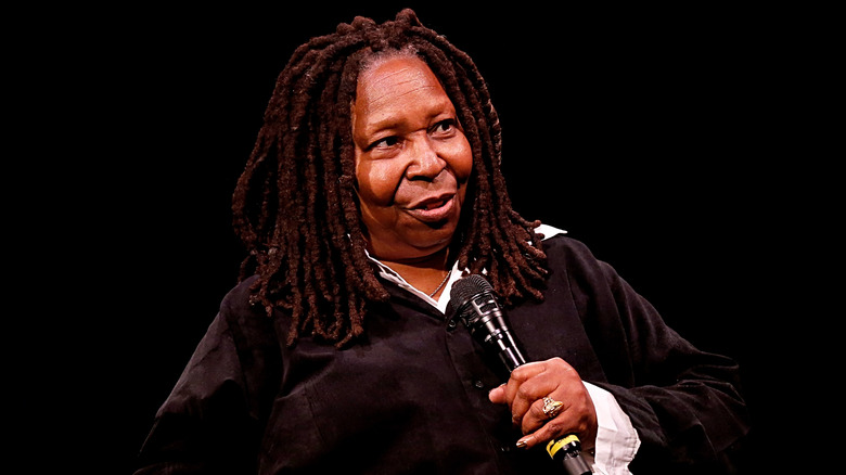 Whoopi Goldberg speaking into micrphone