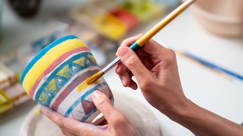 Woman painting a pot