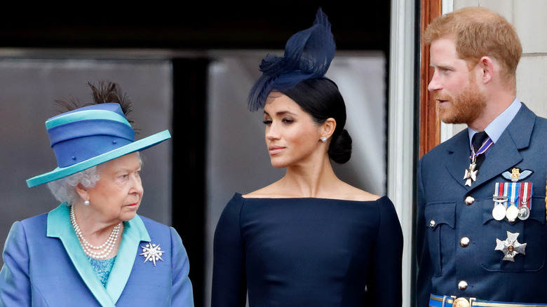 Meghan and Harry look at the Queen