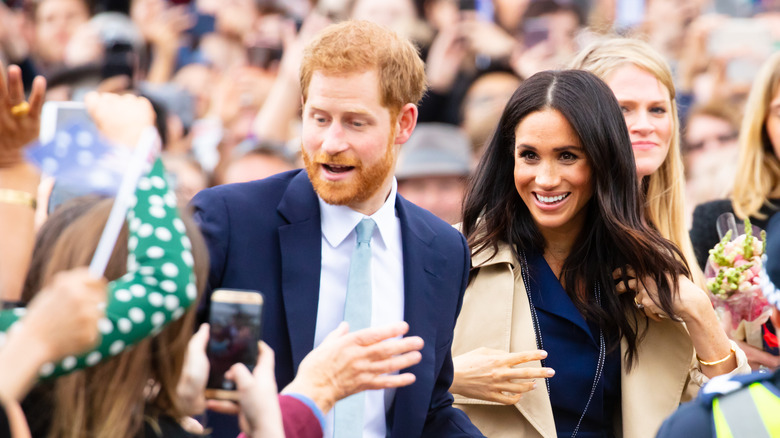 Prince Harry and Meghan Markle with crowds