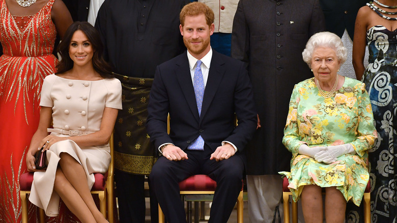 Prince Harry, Meghan Markle and the Queen at an event