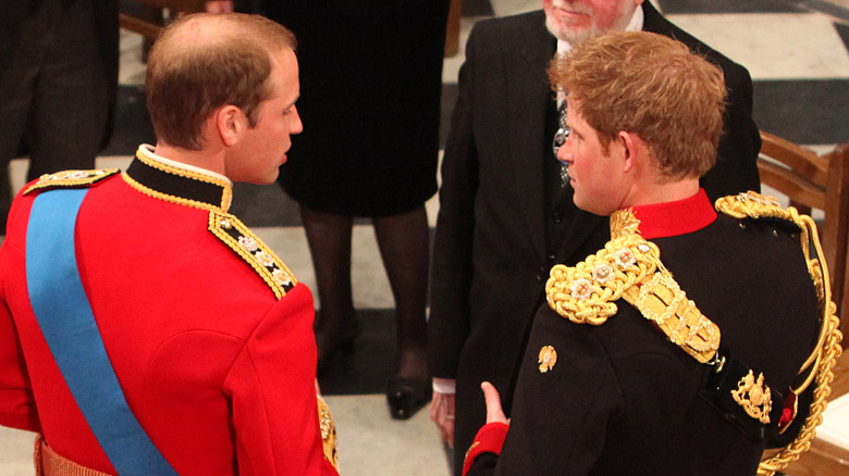 Prince William and Prince Harry talking to each other on William's wedding day