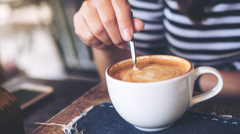 woman stirring coffee