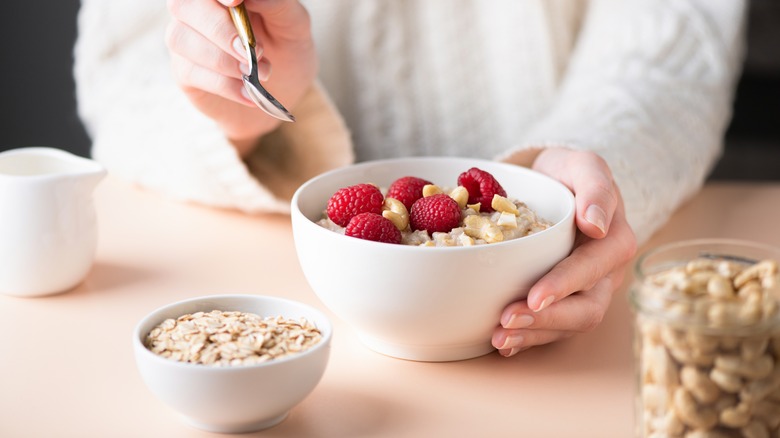 person holding oatmeal bowl