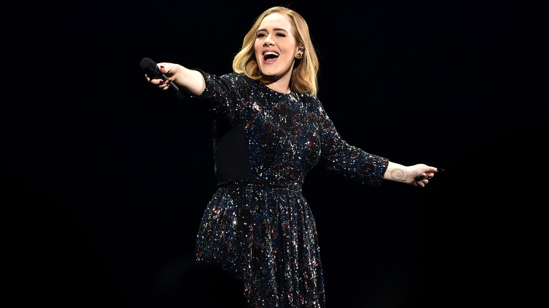 Adele grinning onstage