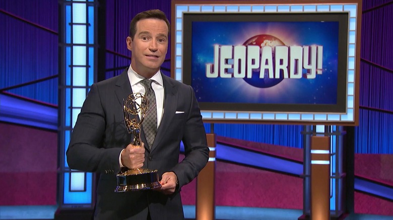 Mike Richards holding an Emmy