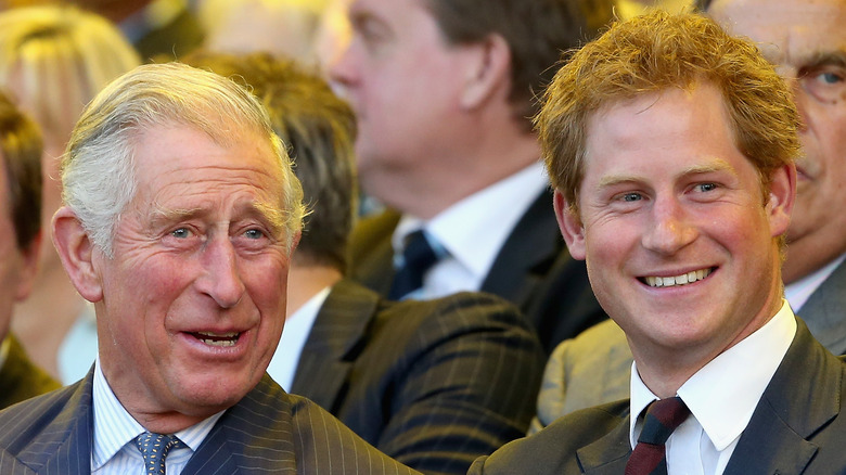 King Charles and Prince Harry laughing at an event