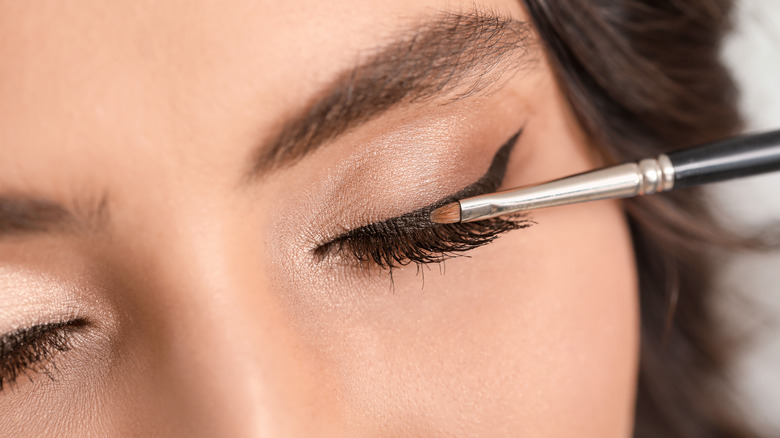 applying gel liner with brush