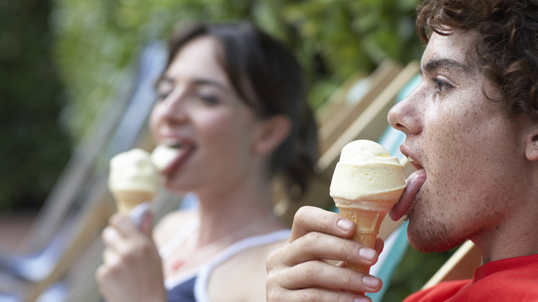 girl and boy licking ice cream cones