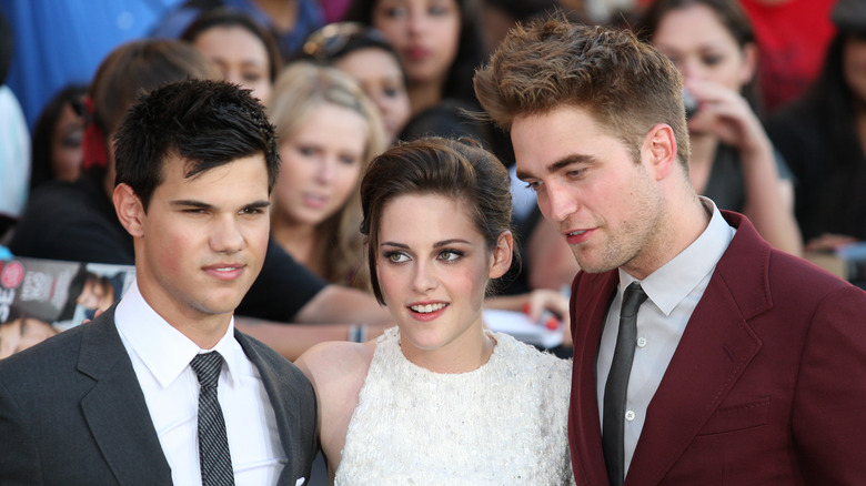 Taylor Lautner, Kristen Stewart, and Robert Pattinson at red carpet