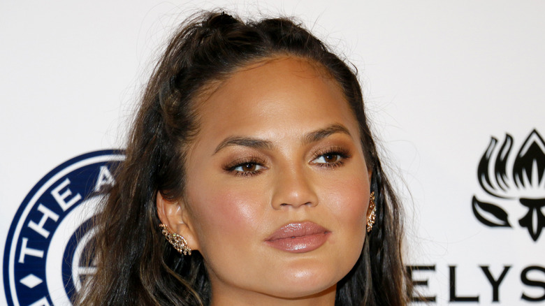 Chrissy Teigen poses on the red carpet