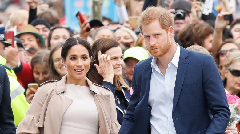 Prince Harry and Meghan Markle greet fans.