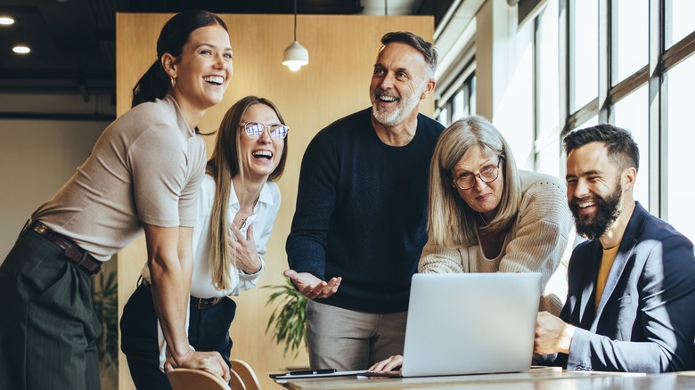 A group of people laughing at work