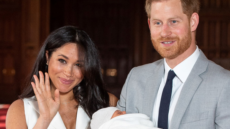 Meghan waving to cameras as she introduces baby Archie alongside Harry