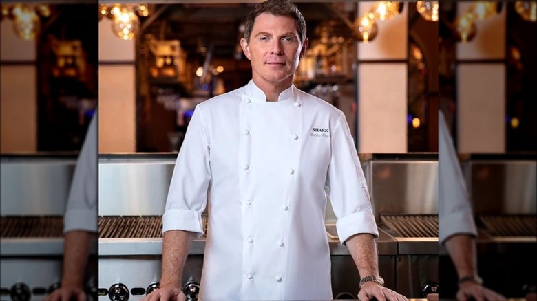 Bobby Flay posing in kitchen