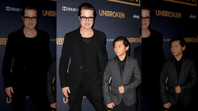 Brad Pitt stands with son Pax Jolie-Pitt at the Unbroken premiere