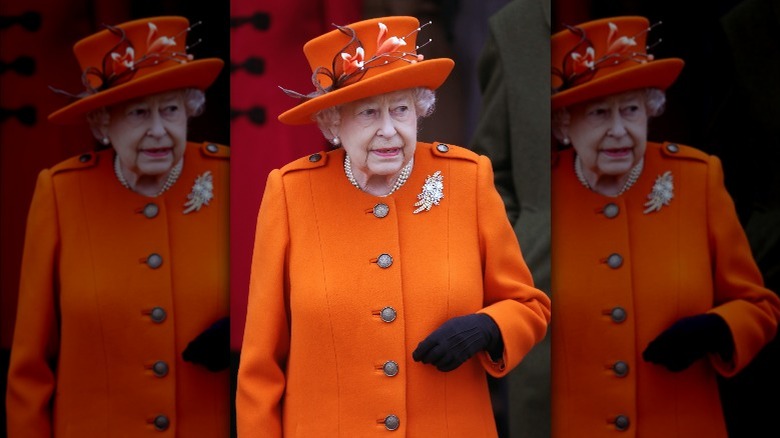 Queen Elizabeth wearing an orange outfit