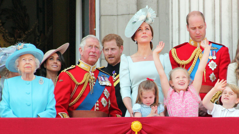 Queen Elizabeth II, Meghan Markle, King Charles III, Prince Harry, Kate Middleton, Princess Charlotte, Isla Phillips, Prince William, and Prince George 