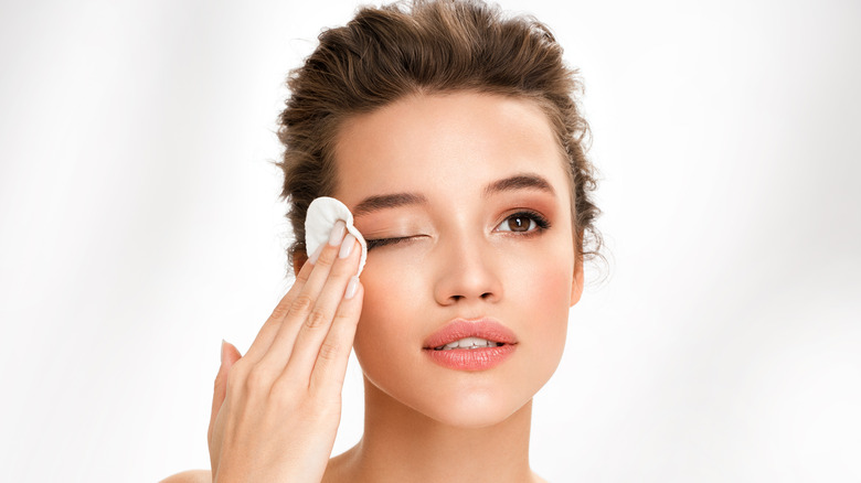 A woman removing eye makeup 