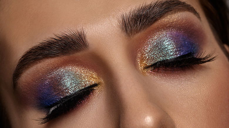 Close-up of woman's eyes wearing cream metallic eyeshadow