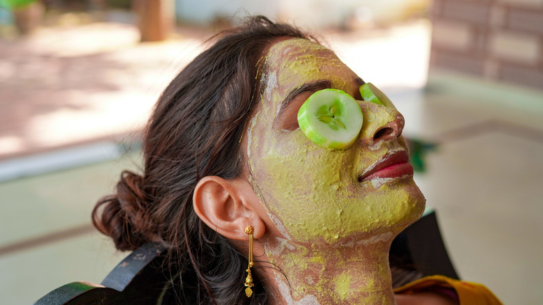 Woman with green mask on face