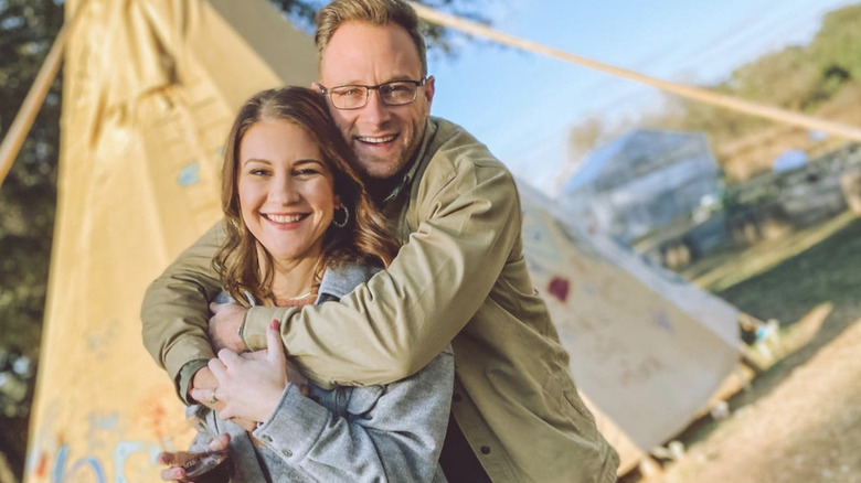 Danielle and Adam Busby posing outdoors