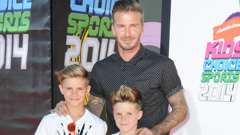 David Beckham smiling with his two sons Romeo and Cruz as young children