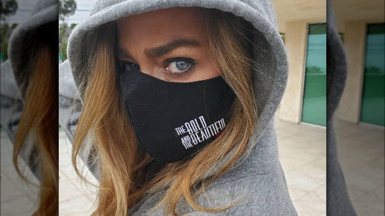 Denise Richards wears a face mask