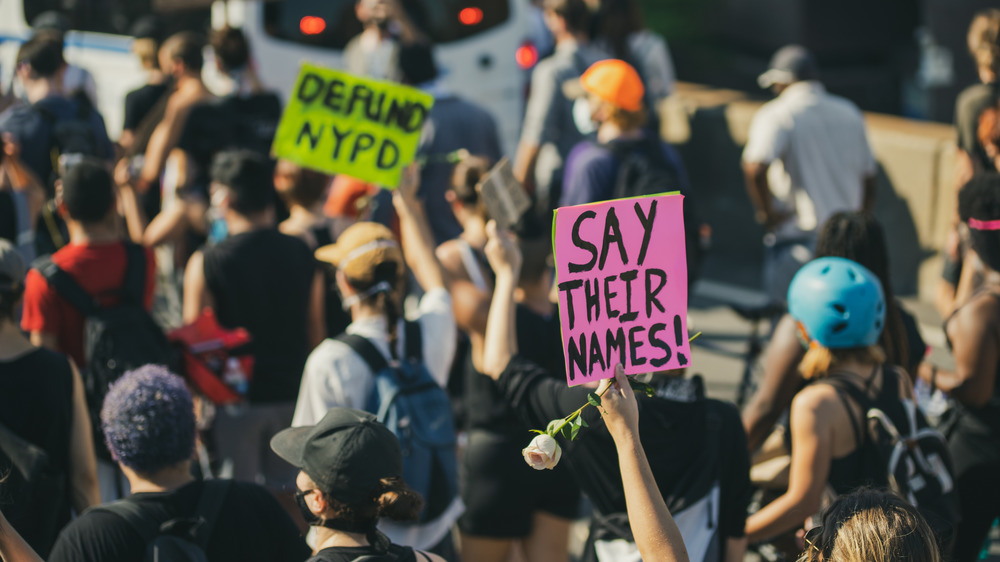 A protest where signs call to defund police