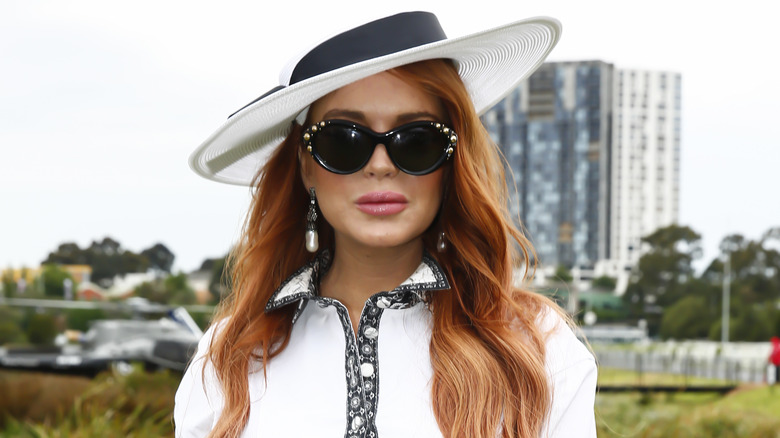 Lindsay Lohan posing in a white hat