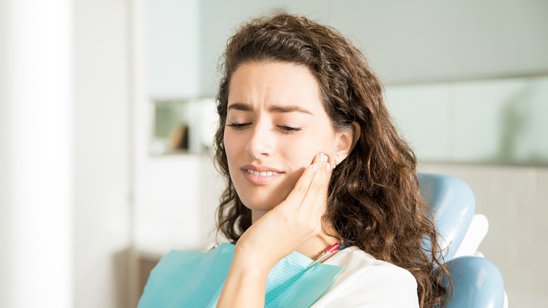 Woman with sore teeth in dentist