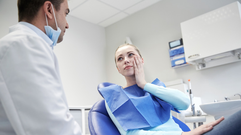 Woman discussing teeth with dentist 
