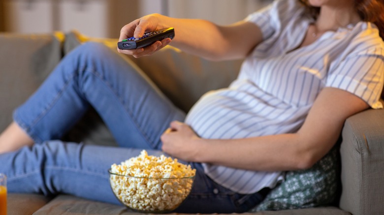 Pregnant woman eating popcorn