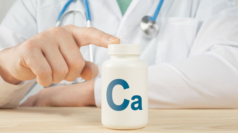 Doctor with calcium supplement bottle