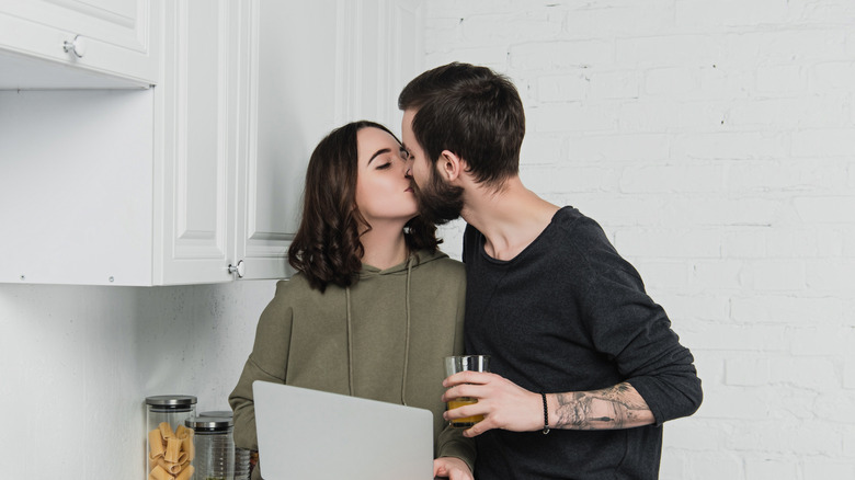 Man kissing woman